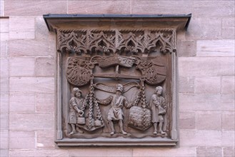 Copy of the old relief Kleine Stadtwaage from 1472 on the facade of the Chamber of Industry and Commerce
