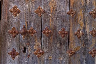 Old wooden door with fittings and keyhole