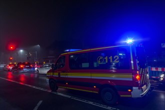 Fire brigade rescue vehicle on a road at night