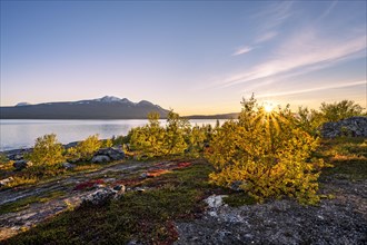 Autumnal fell landscape with lake Akkajaure and mountain range Akka
