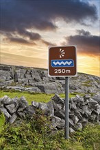 Wavy logo on a sign marks viewpoint in karst landscape