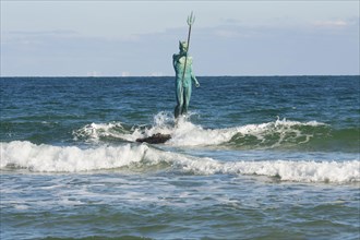 Sculpture of Neptune in sea near the beach