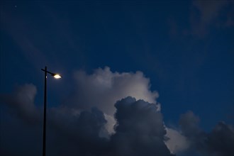 Evening sky with clouds and street lamp