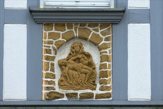 Religious relief on a historic half-timbered house from 1850