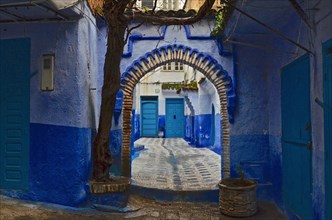 Moorish round archway and blue wall in front of house entrance