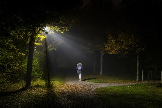 A woman walks through a lonely park in Markt Swabia