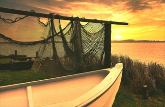 Fishing nets and fishing boat in the sunset