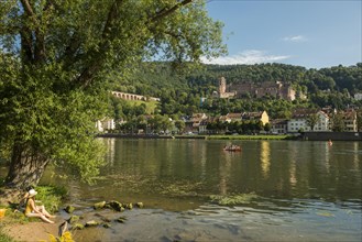 Young people in the evening sun on the Neckar