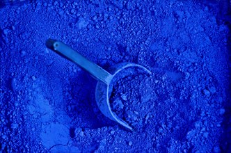 Shovel in bag with blue paint powder