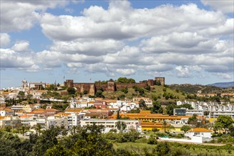 Silves cityscape with Moorish castle and cathedral on the top of the hill