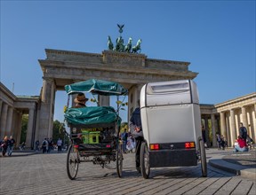 Guides with bicycle carriages wait for passengers in front of the Brandenburg Gate