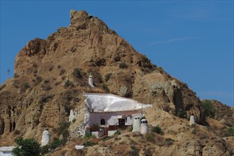 Mountain with cave house in cave district of Guadix