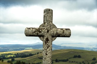 Stone cross. Massif of Sancy. Auvergne Rhone Alpes. France
