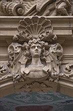 Man's head and shell in half relief above the entrance portal of the Baroque Boettinger House