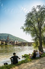 Young people in the evening sun on the Neckar