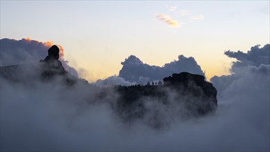 Roque Nublo shrouded in clouds at sunset