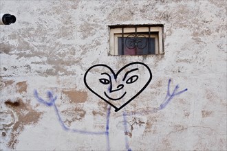Painted smiley heart under window painted on wall