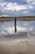 Man standing on the beach in the evening