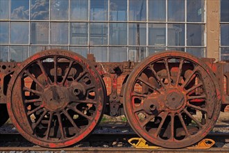 Railway wheels in front of factory hall
