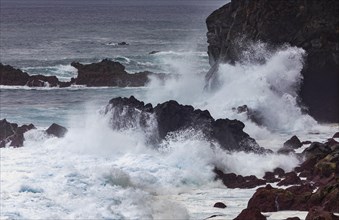 Stormy sea with high waves on the rocky coast near Ribeira Grande