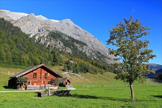 Alpine hut in front of mountain range