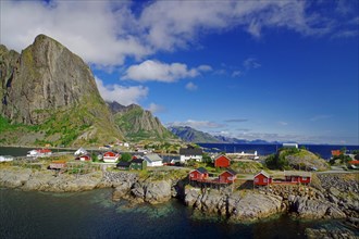 Scandinavian landscape with wooden houses by the fjord