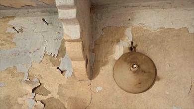 Funnel on shabby wall with nails