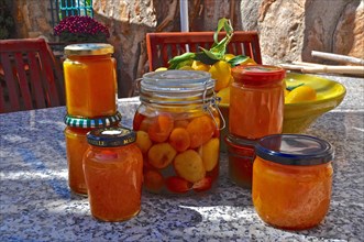 Jam jars on outdoor stone table