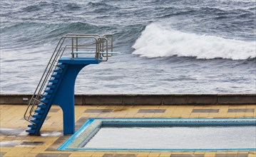 Swimming pool with diving tower on the Atlantic coast
