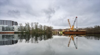 Office building and construction crane on the industrial site at Borsighafen in Berlin Tegel