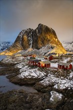Winter Scandinavian landscape with illuminated red houses