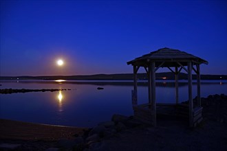 Full moon over a body of water