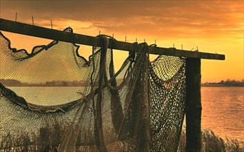 Suspended fishing nets in the sunset