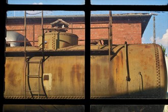 View through factory window on diesel tank at station