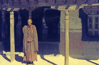 Buddhist monk in front of monastery in Tikse