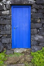 Lava stone house facade with blue front door