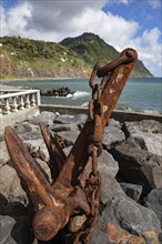 Old rusty anchor as a monument on the promenade