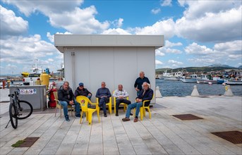 Sardinian seniors meet in the harbour area of Figari at Golfo Aranci