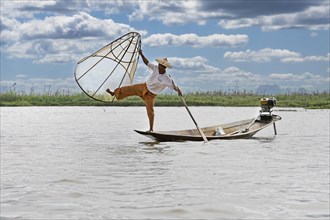 Fisherman at Inle Lake with traditional Intha conical net
