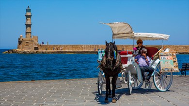 Panorama harbour town of Chania with tourist carriages