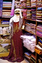 Traditional garments with burqa for Bedouin woman in the souq