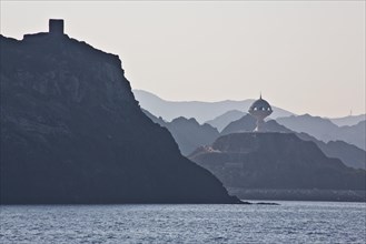 Coast near Muscat with view of fortifications and monument incense burner