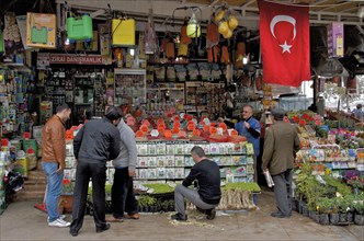 Men in front of plants and spice shop with Turkish flag in Eminoenue district