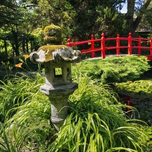 Japanese Garden with Stone Lantern and Red Bridge