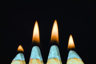 Four flames on match heads