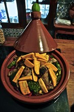 Pumpkin wedges with chicken and broccoli in Moroccan tajine