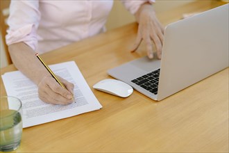 Woman proofreading at her desk