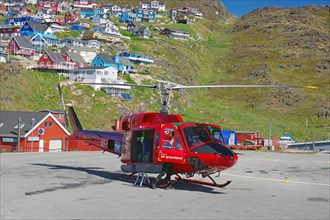Air Greenland helicopter in front of multicoloured houses