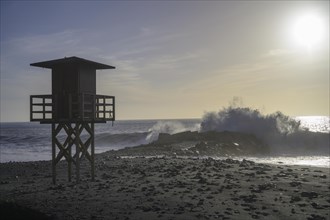 High waves crashing on the beach at a lifeguard lookout