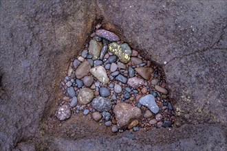 Triangular hollow filled with stones